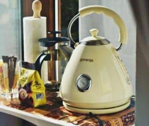 Creamy yellow coloured electric kettle on a kitchen bench