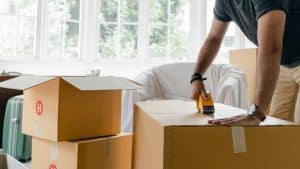 Man packing boxes in his lounge