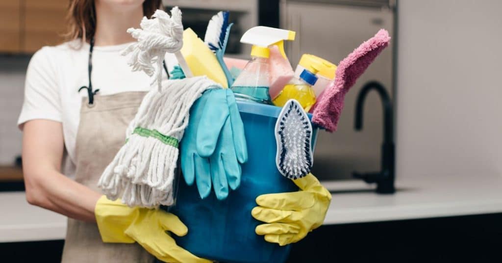 Cleaner holding bucket of cleaning materials
